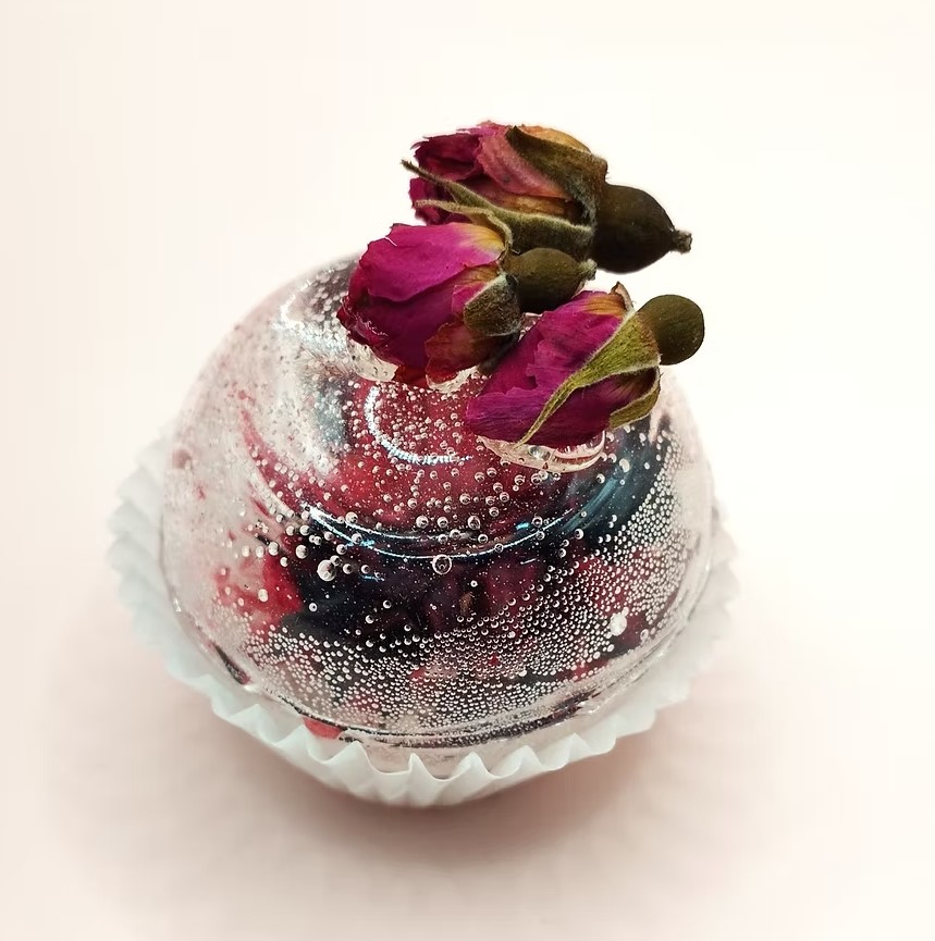 Tea sphere with dried rosebuds set on top