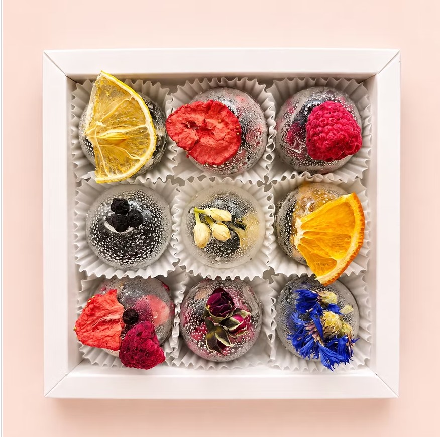 Gift box with nine handcrafted tea spheres decorated with orange, strawberry, raspberry, jasmine and cornflower