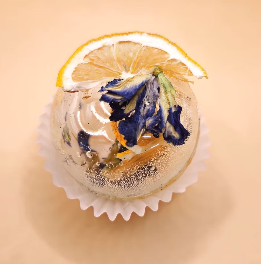 Tea sphere with blue butterfly pea flowers and a lemon slice
